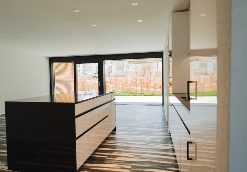 modern kitchen with large windows, wooden floor, black and white cabinets, central island