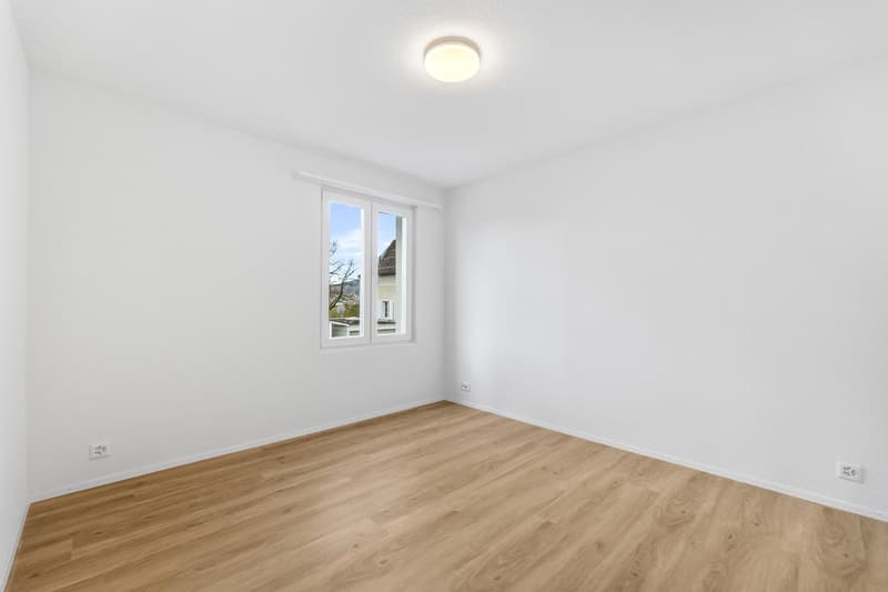 empty room, white walls, wooden floor, window, power outlets