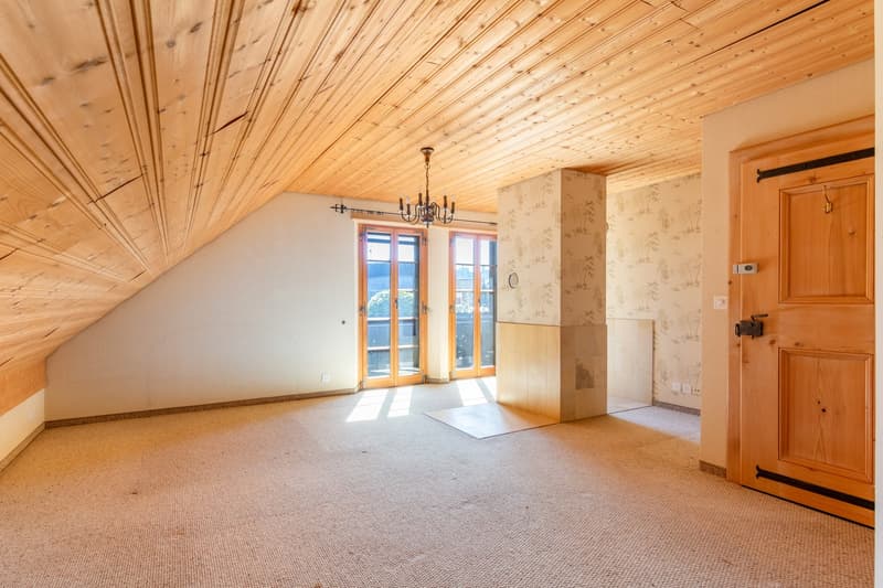 empty room, wooden ceiling, carpeted floor, chandelier, glass doors, balcony