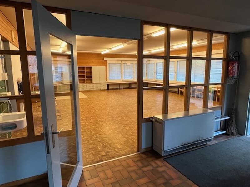 empty room, large windows, tiled floor, wood shelves, open door