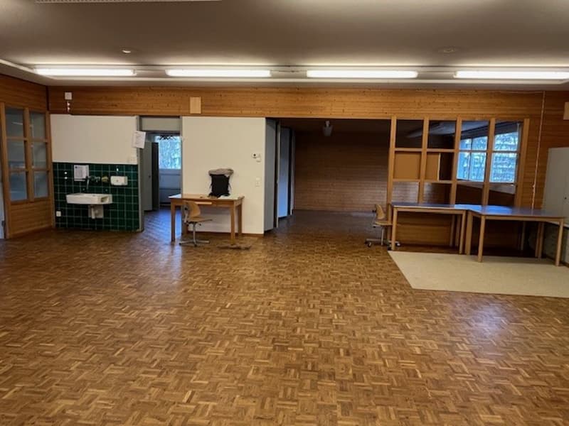 wooden floor, two tables, chairs, sink, shower, wooden wall
