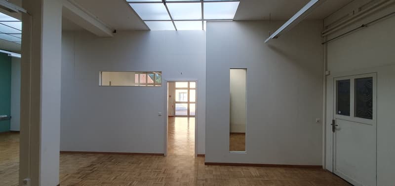 Empty room with wooden floor, white walls, glass windows, glass door, glass ceiling