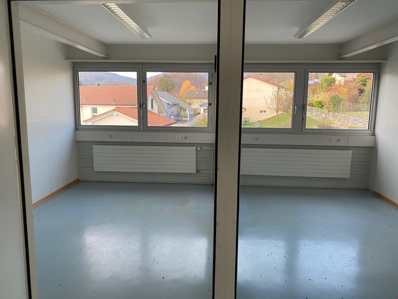 empty room, white walls, large windows, white floor, two heaters