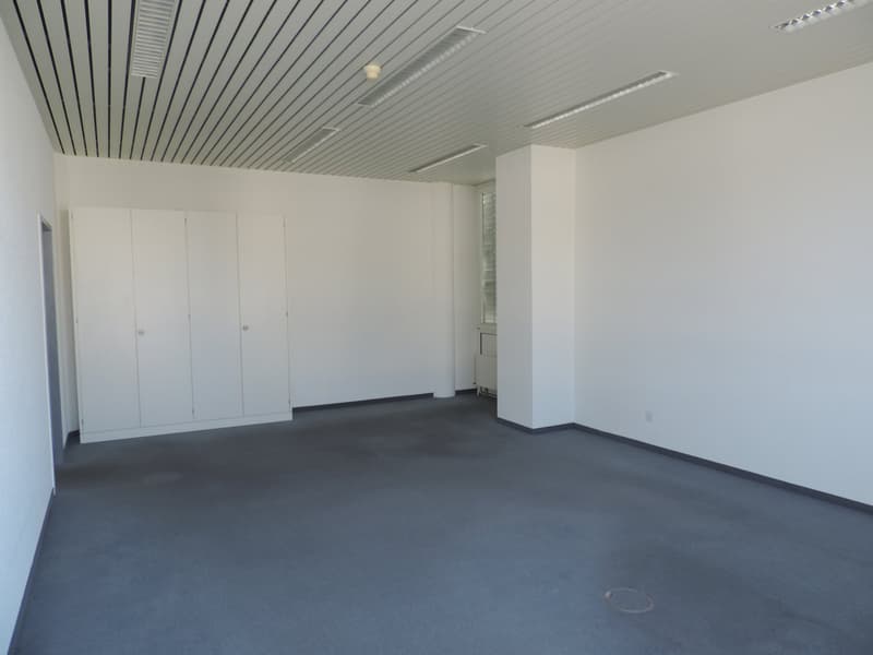 Empty room, carpeted floor, white walls, white cabinet, power outlet