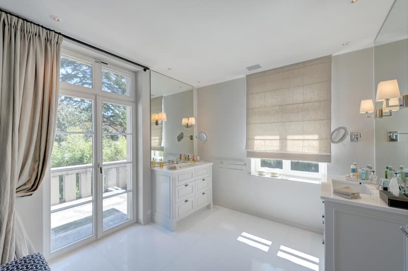 Helles Badezimmer mit eigenem Balkon und hochwertiger Ausstattung. Auch die weiteren Bäder überzeugen durch edle Materialien und ein modernes Design.