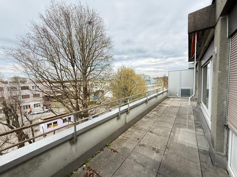 Concrete floor, metal railing, view of the city
