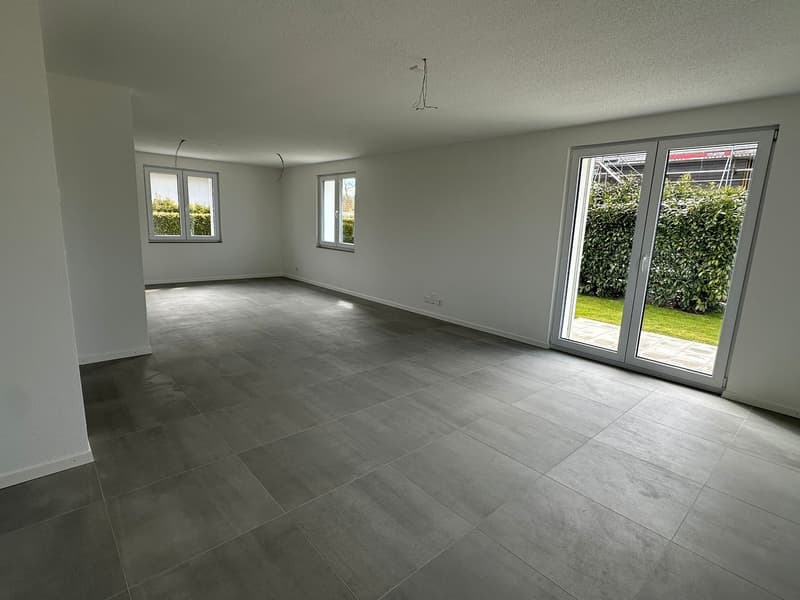 empty room, white walls, gray tile floor, sliding glass doors, windows