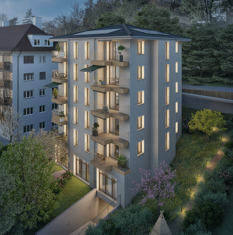 Apartment building with 5 stories, solar panels on the roof, multiple balconies, garden area, pathways, multiple trees and plants