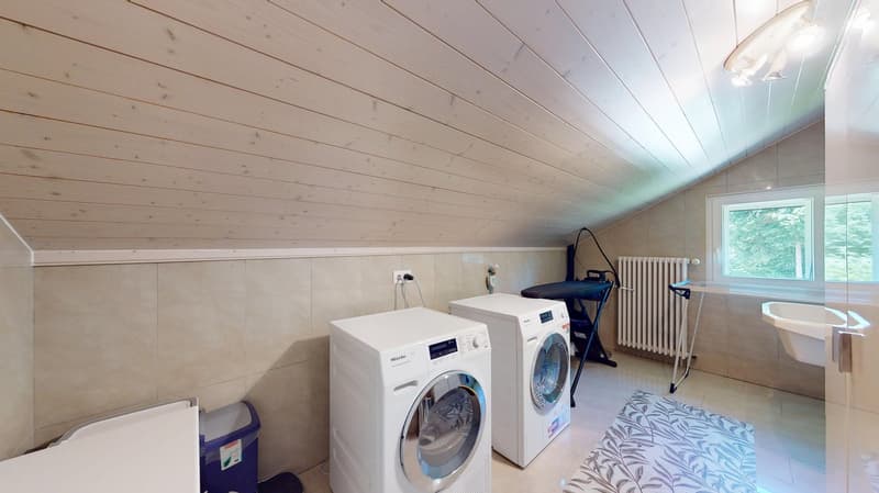 laundry room with two washers, drying rack, iron board, sink, tiled flooring