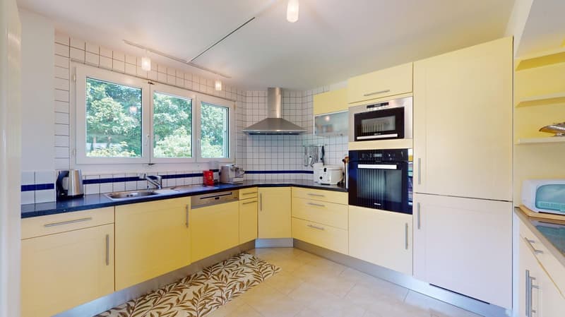 modern yellow kitchen, tiled floor, blue countertop, double oven, dishwasher, window, exhaust fan
