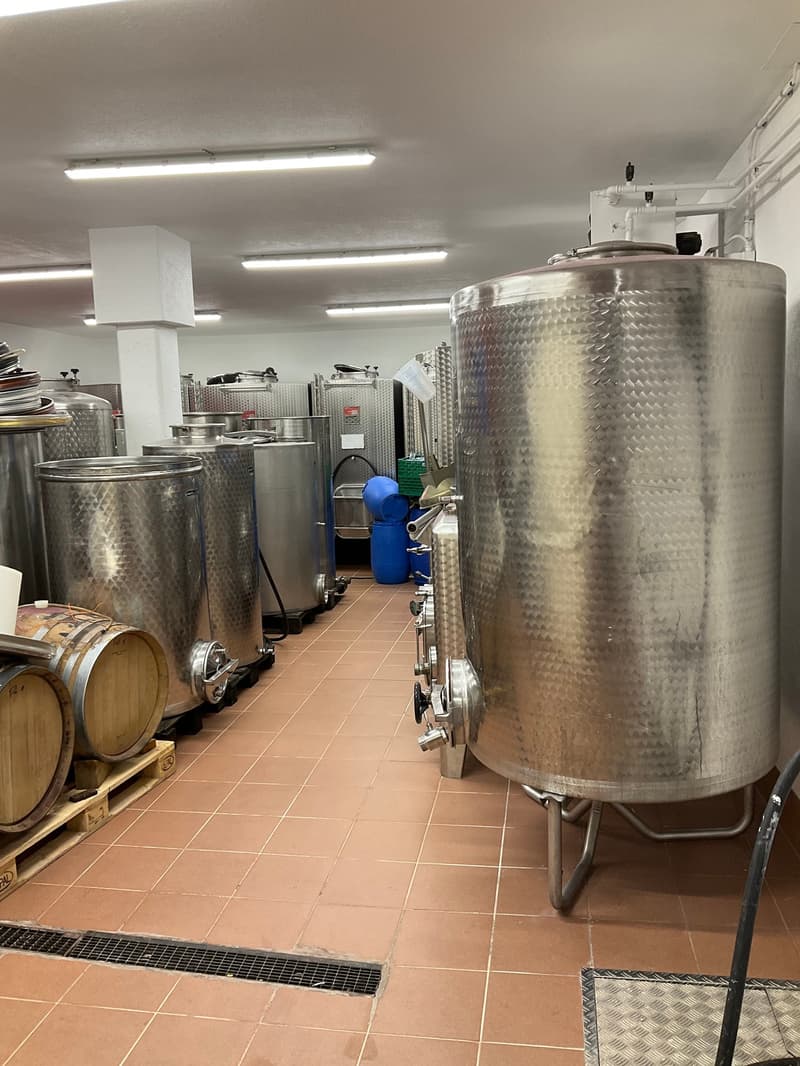 Metal tanks, barrels, tiled floor, metal grate