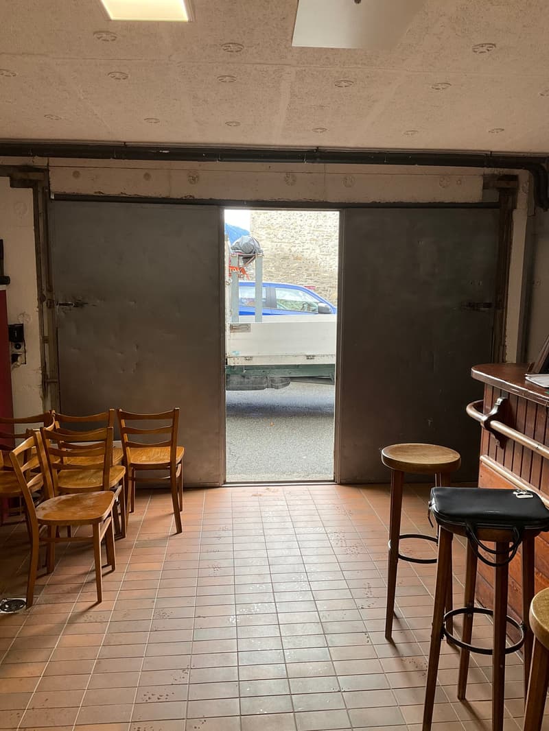tiled floor, double doors, open to garage, pickup truck in view, wooden chairs and stools