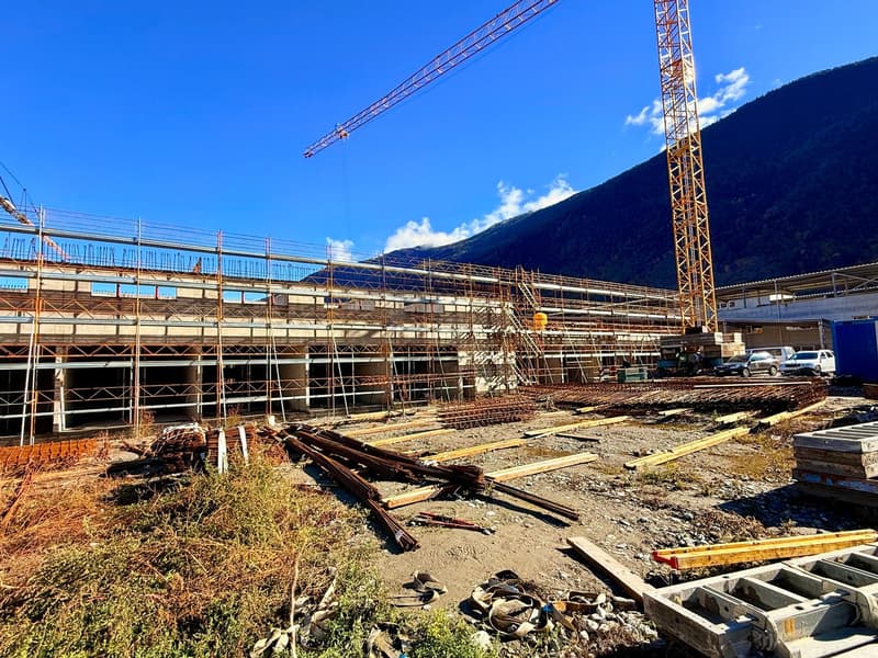 Construction site with cranes, scaffolding, and construction materials