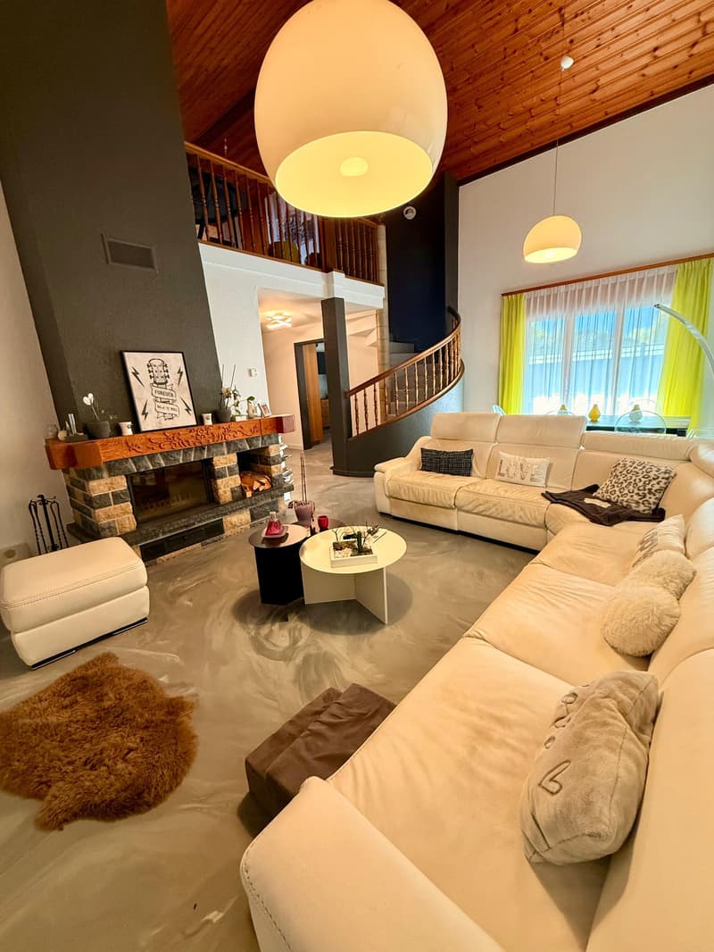 living room with fireplace, modern furniture, white sofa, coffee table, carpet, staircase, lamps