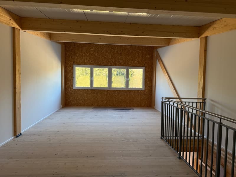 empty room, wooden beams, wooden floor, white walls, large window