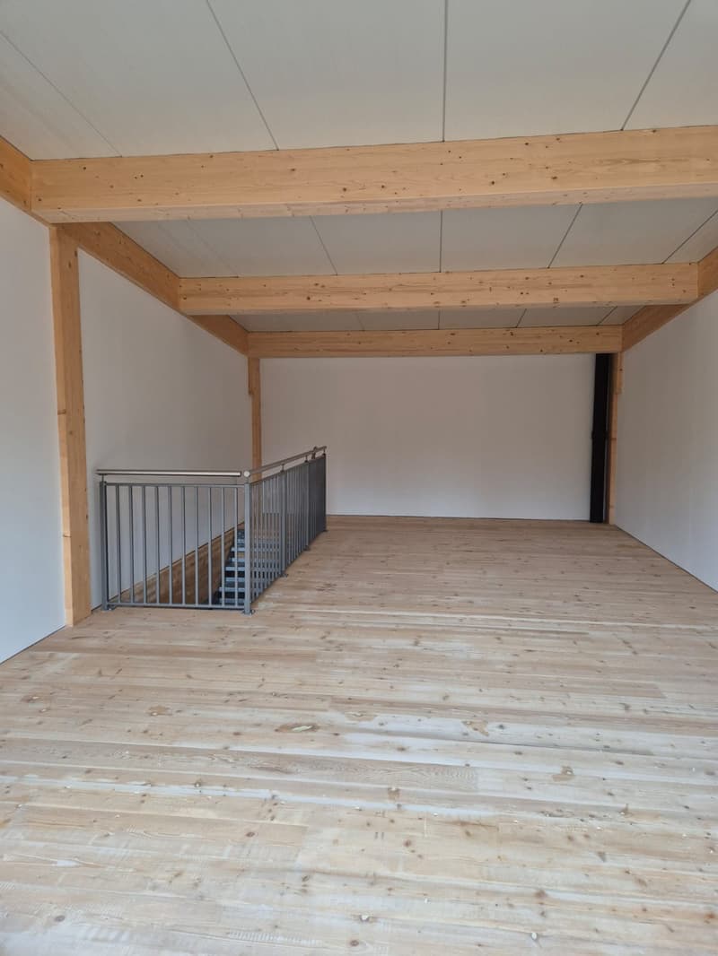 empty room, wooden floor, wooden beams, metal railing, stairs