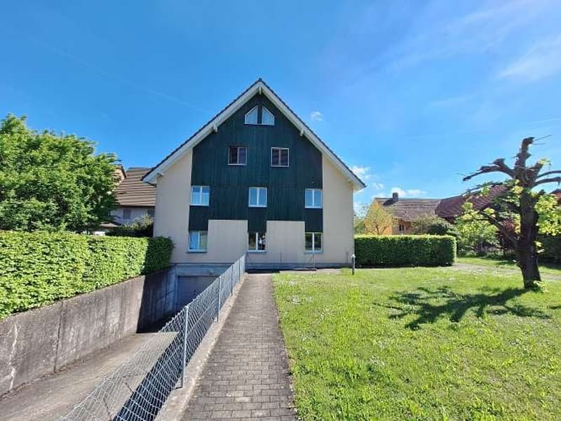 2 story house, green and white exterior, brick walkway, garden, garage