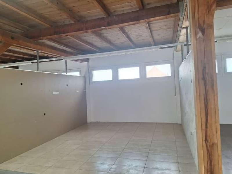 empty room, tiled floor, wooden beams, white walls, three windows