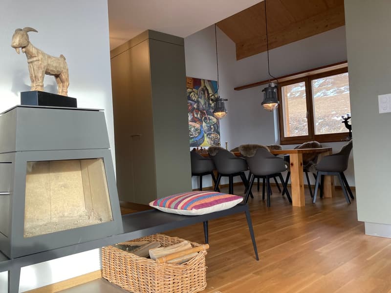 wooden floor, fireplace, dining table, chairs, wooden cabinet, painting, window, goat statue