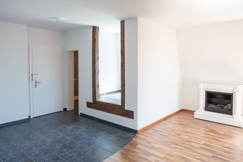 white walls, wooden floor, large fireplace, wooden window frame, grey tiles