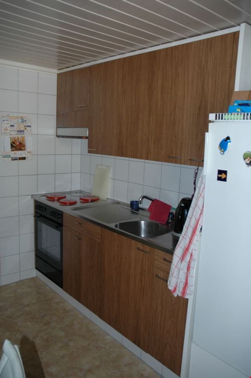 kitchen with wooden cabinets, white tiles, stainless steel sink, electric stove, oven, refrigerator