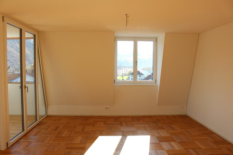 empty room, wooden floor, sliding glass doors, window, balcony, mountain view