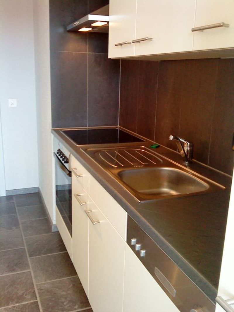 modern kitchen with white cabinets, stainless steel countertop, gas stove, oven, dishwasher, sink, faucet