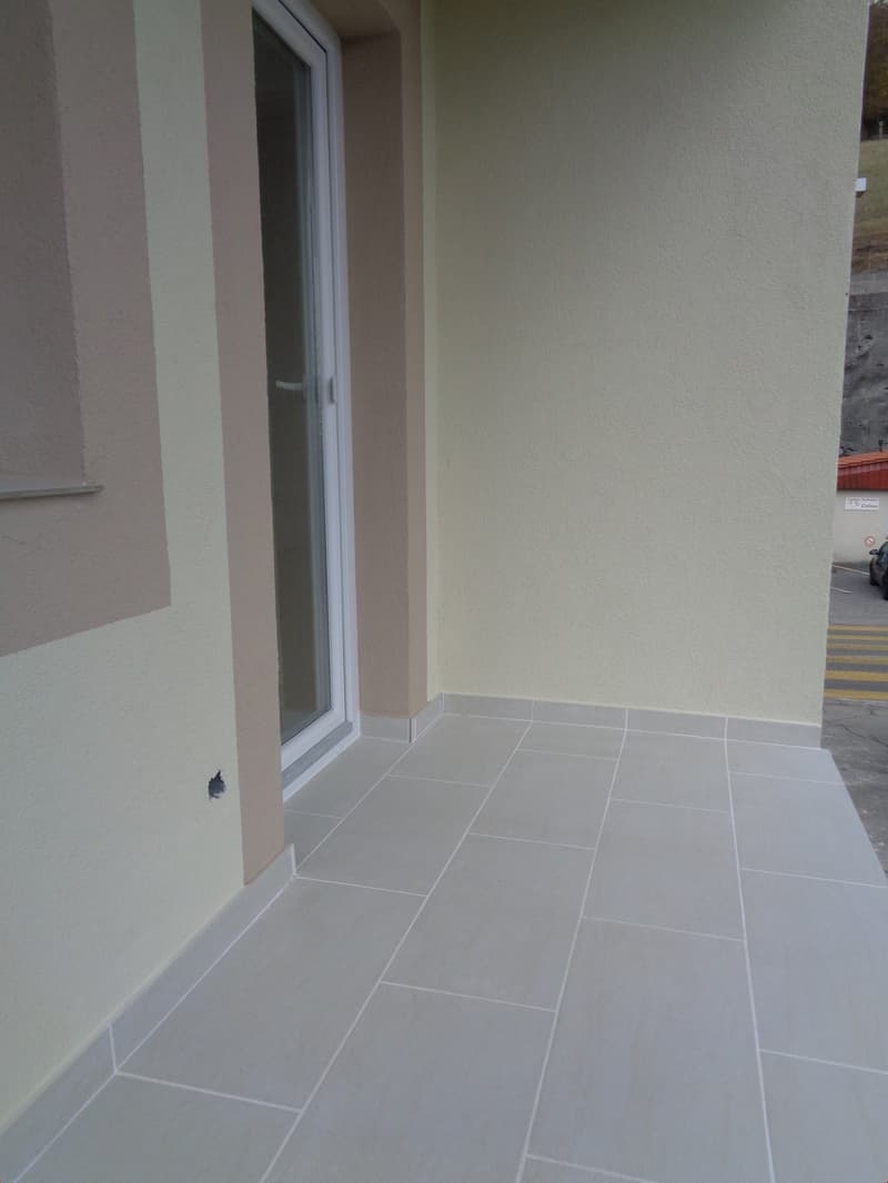 tiled floor, glass door, walls are painted beige and off-white, window on wall