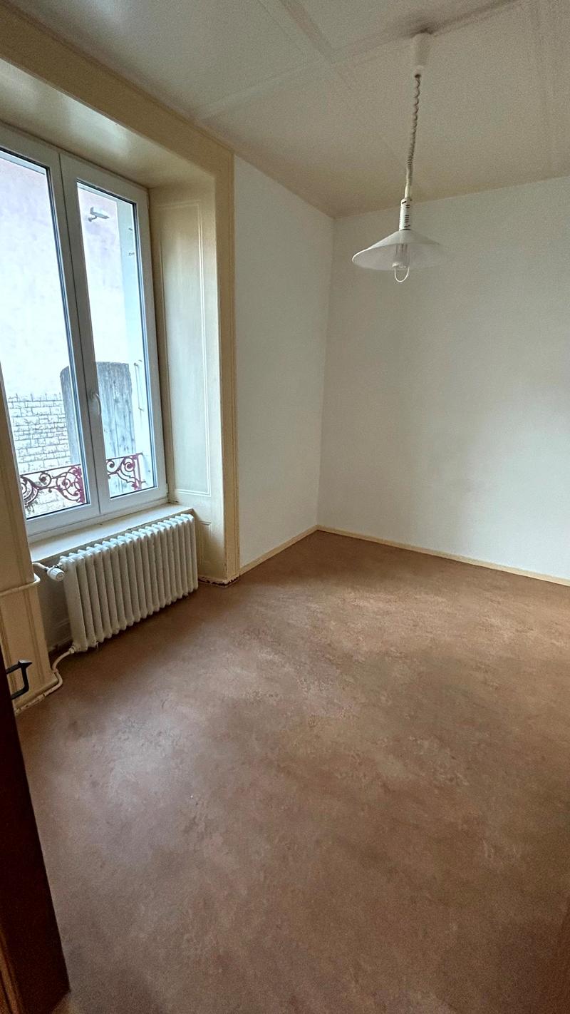 empty room, white walls, windows, ceiling light, radiator, balcony