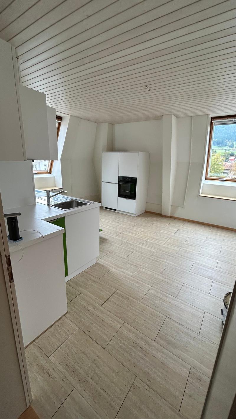 kitchen with tiled flooring, white cabinets, refrigerator, oven, sink, and two windows.