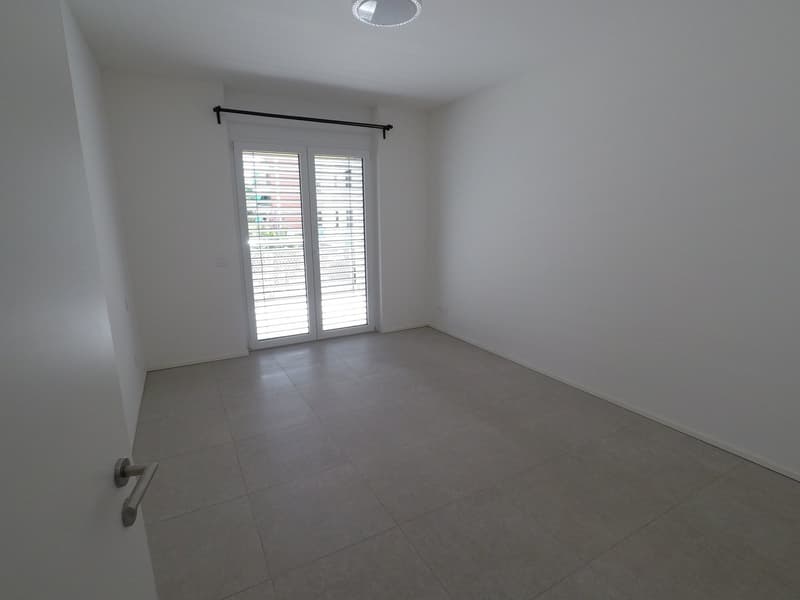 empty room, tiled floor, sliding glass door, white walls, ceiling lamp