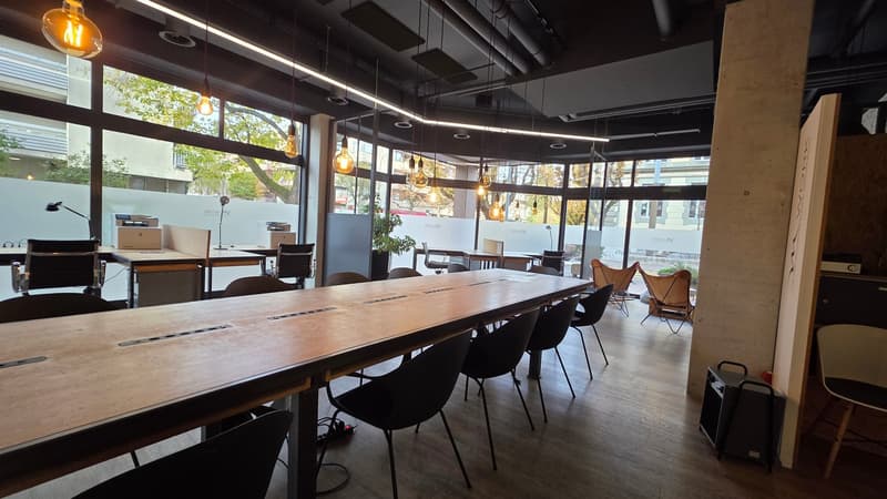 Wooden desk, chairs, tables, wooden flooring, pendant lamps, windows