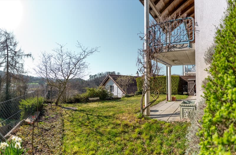 House with balcony, garden, and a small house in the background
