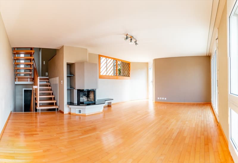 large room, hardwood floors, fireplace, staircase, windows