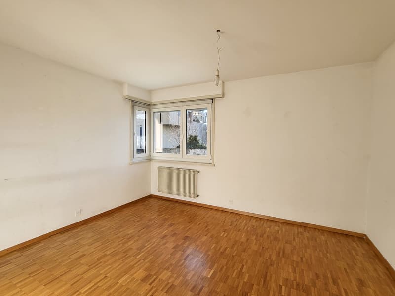 empty room, white walls, wooden floor, white ceiling, radiator, two windows