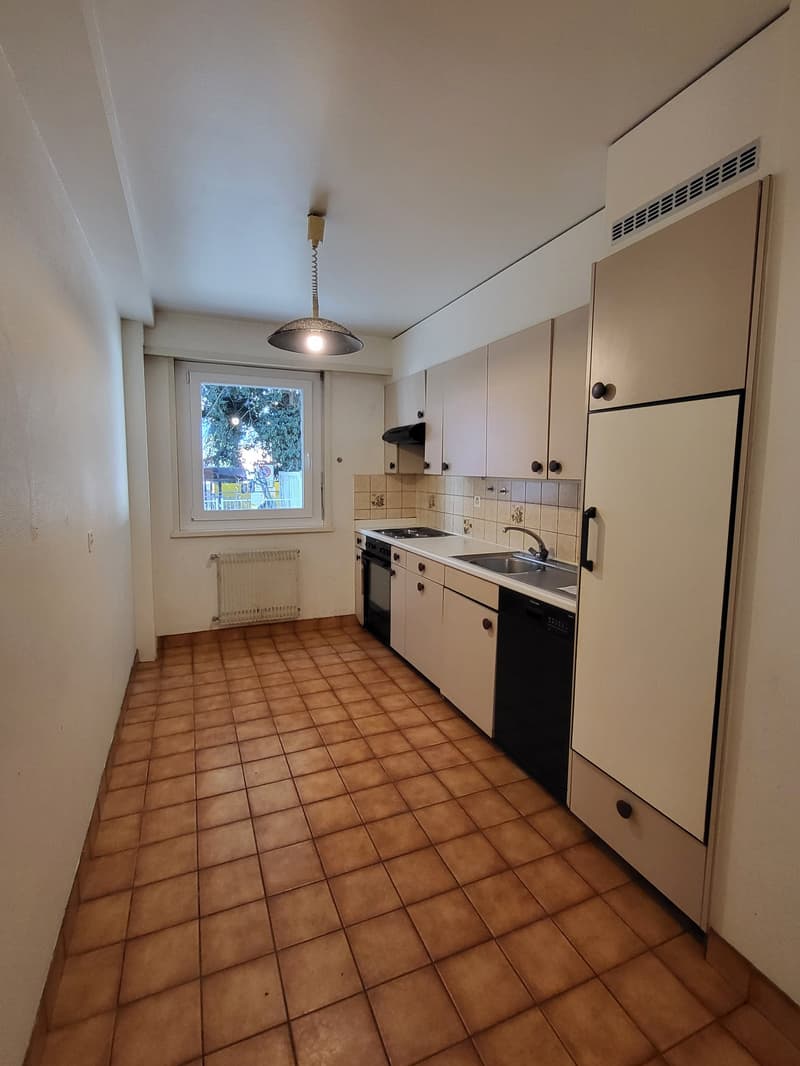 modern kitchen, tile flooring, white cabinets, sink, dishwasher, gas stove, window