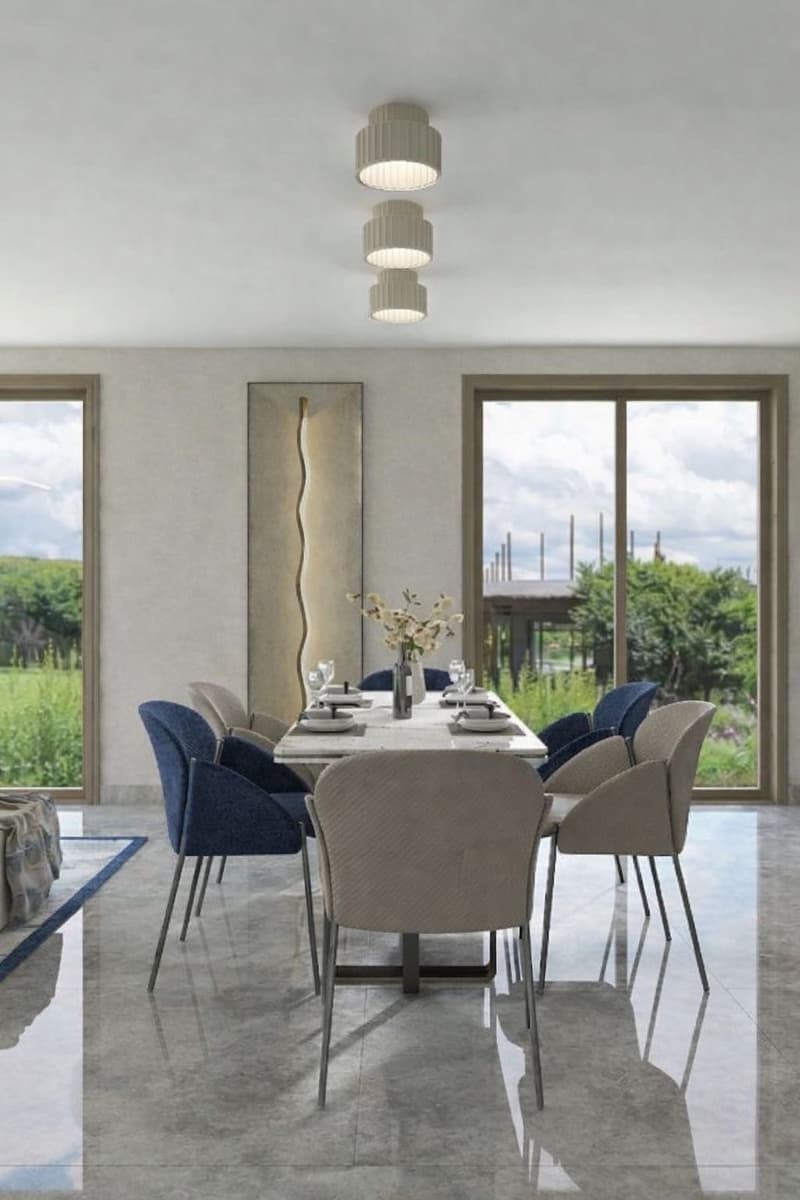 Dining room with a large table, blue chairs, white walls, large windows, and a view of the outside