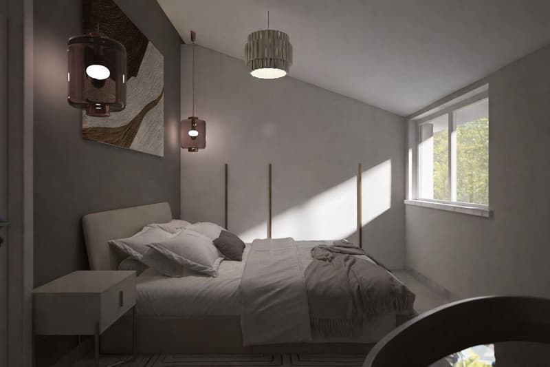 Bedroom with a bed, nightstand, and wall art. The room has a modern design with gray walls and a white ceiling. The bed has a headboard and is covered with a white blanket and pillows. There is a nightstand with a drawer on the left side of the bed. The r