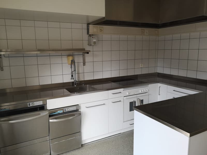 white cabinets, silver appliances, stainless steel countertop, white tiles, stainless steel sink, faucet, large oven, extractor hood, electrical outlets