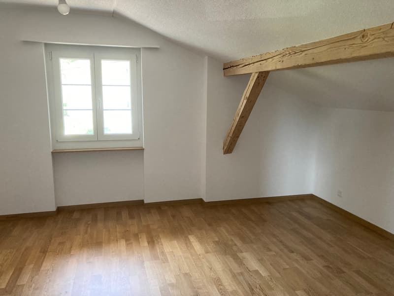 empty room, hardwood floors, single window, wooden ceiling beams