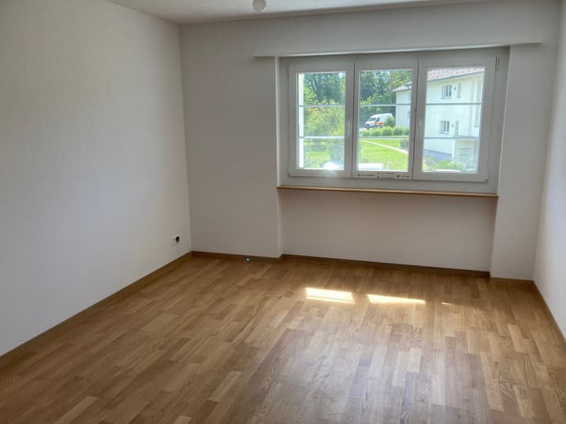 Empty room, wooden floor, white walls, double window, no furniture