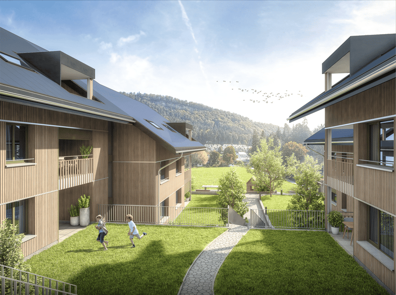 2 story building, wooden exterior, metal fencing, lawn, children running, hills in the background