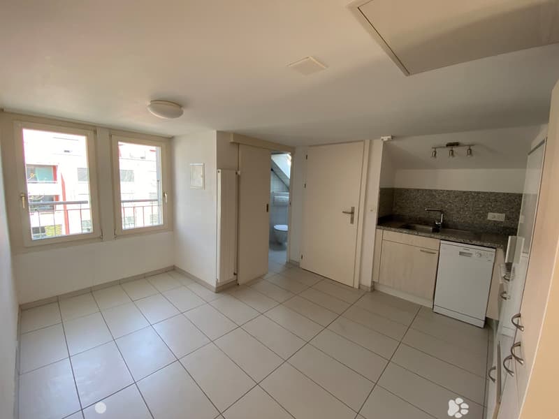 Empty kitchen with white tiles, wooden cabinets, sink, dishwasher, and windows