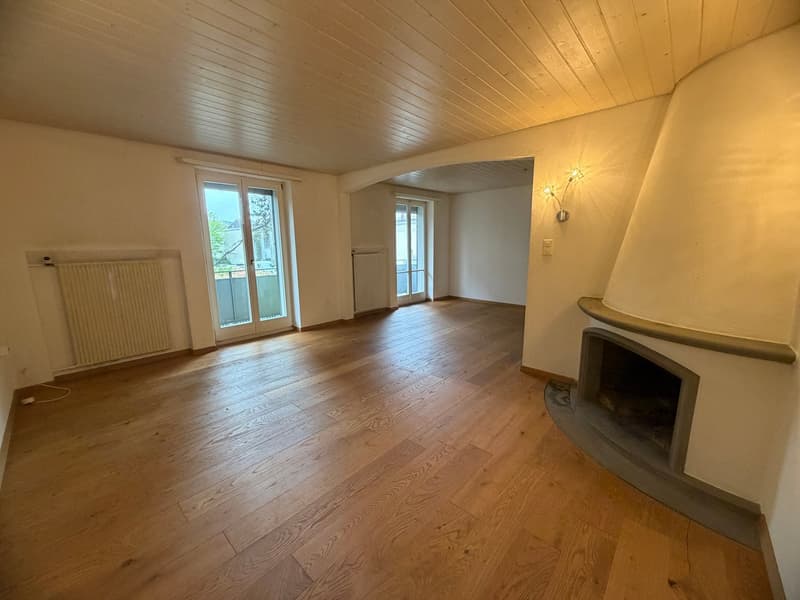 empty room, wooden floor, fireplace, sliding glass doors, radiators, wall lamp