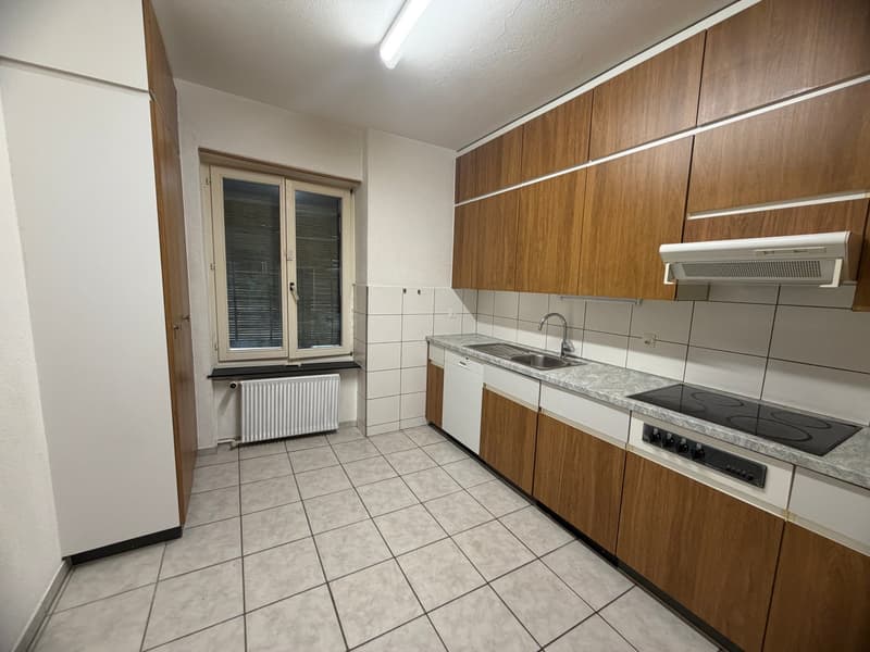 modern kitchen with wooden cabinets, white tiled floor, white appliances, sink, stove, window with blinds