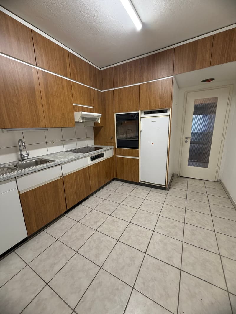 modern kitchen with wooden cabinets, granite countertop, white appliances, tiled floor