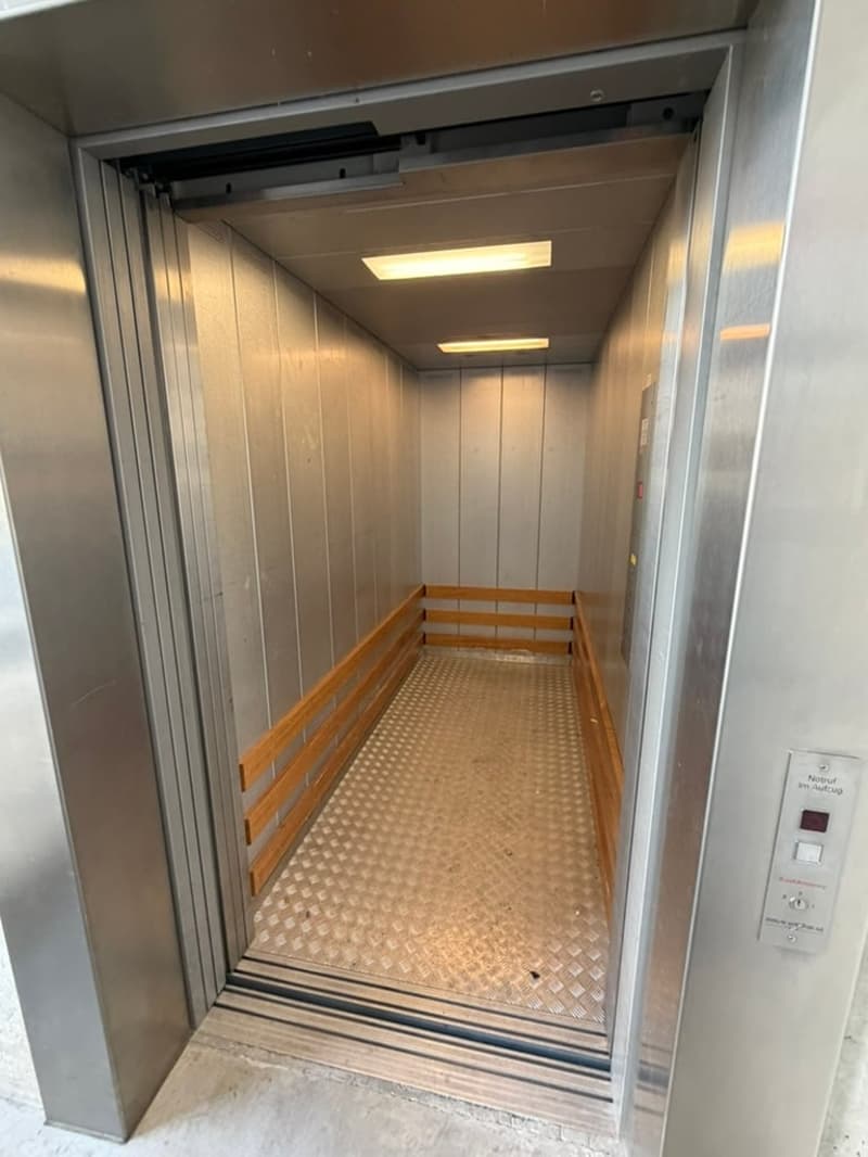 empty elevator with wooden ramps and metal floor