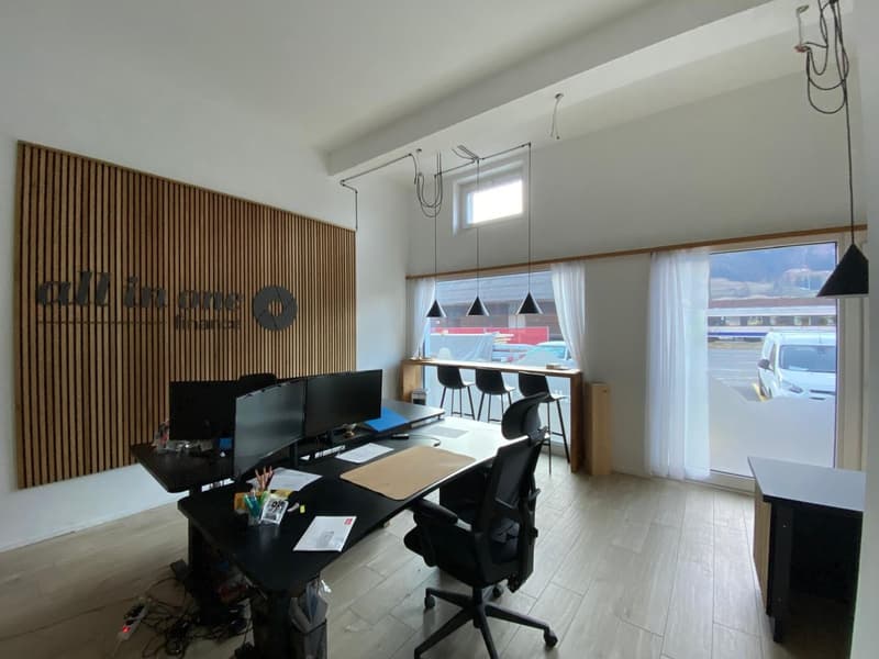 modern office with wooden wall, black desk, computer monitors, office chairs, white curtains, wooden floor