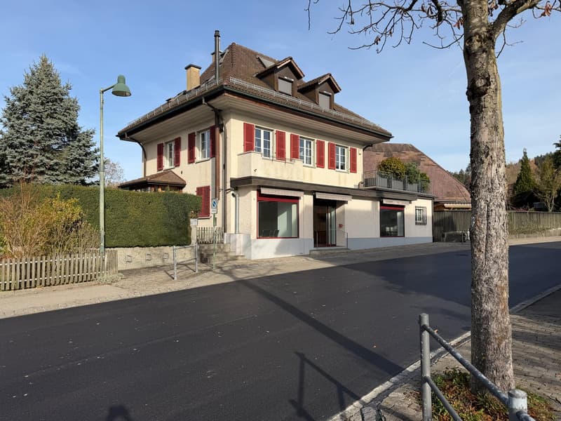3 story house with brown roof, red shutters, chimney, white wall with red accents, glass windows, glass door