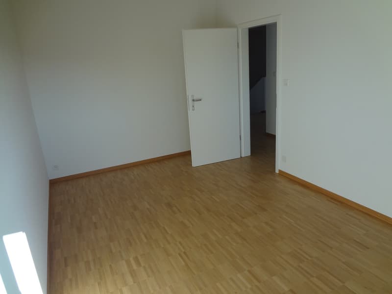 empty room, wooden floors, white walls, closed doors, power outlets